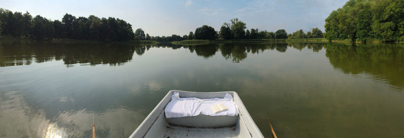 Calm lake with trees in background