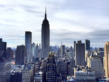 City skyline against cloudy sky