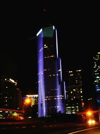Illuminated city against sky at night