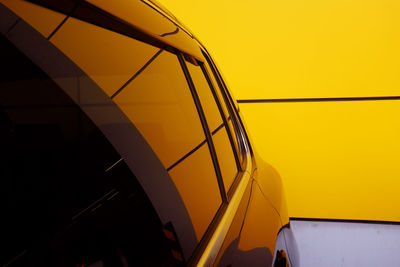 Close-up of yellow wheel against sky during sunset