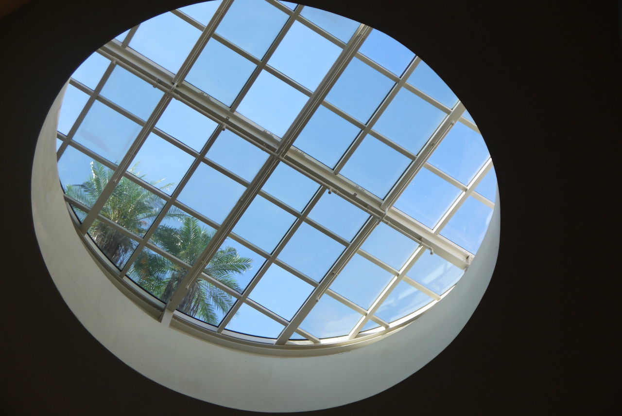 LOW ANGLE VIEW OF SKYLIGHT AGAINST SKY SEEN THROUGH WINDOW
