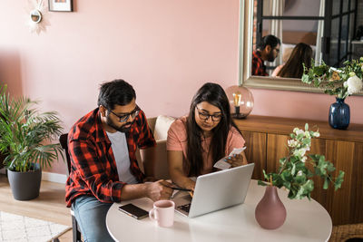 Young woman using laptop at home