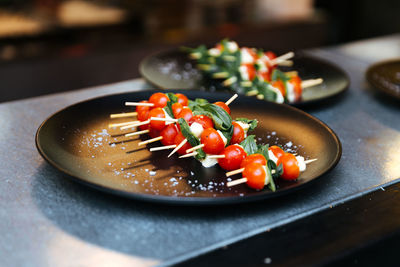 Skewed vegetables in plate on table