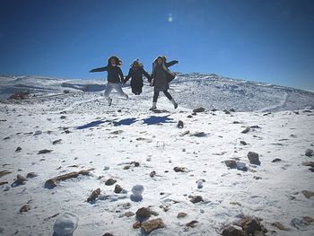 People walking on rocks during winter