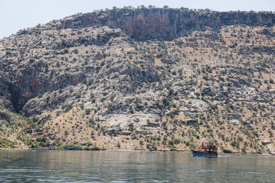 Scenic view of river by tree mountain