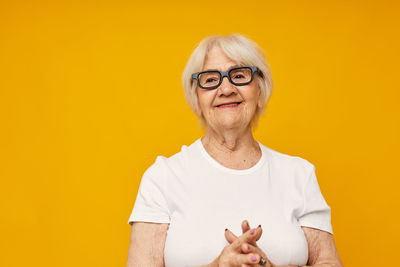 Portrait of young man against yellow background