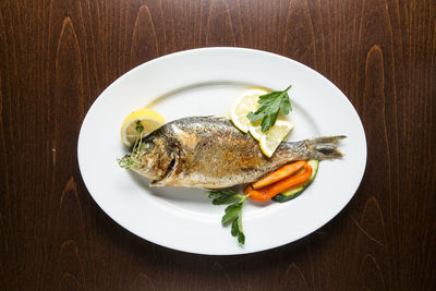 High angle view of fish in plate on table