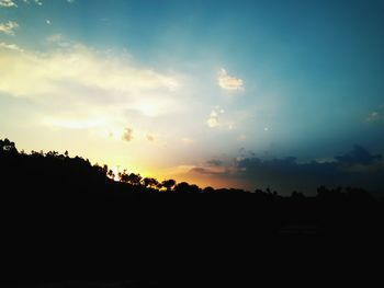 Silhouette trees against sky during sunset