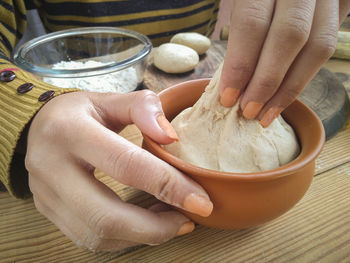 Midsection of woman preparing food on table