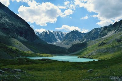 Scenic view of lake and mountains against sky