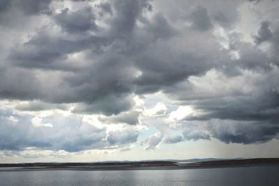 Scenic view of sea against cloudy sky