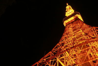 Low angle view of illuminated tower at night