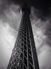 Low angle view of eiffel tower against cloudy sky