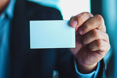 Close-up of human hand holding paper
