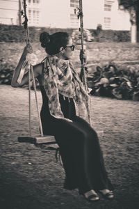 Young woman swinging at park