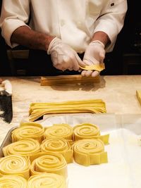 Midsection of chef preparing food in kitchen