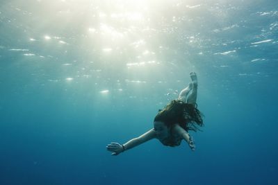 Young woman swimming in sea