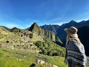 Woman standing against machu picchu