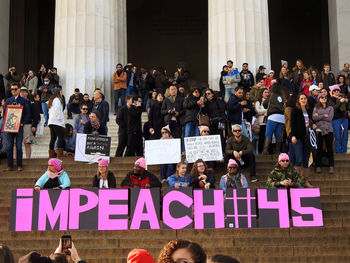 People standing by text on wall