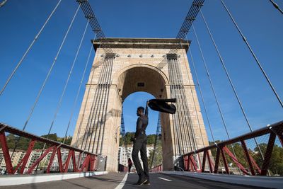 Low angle view of bridge against blue sky