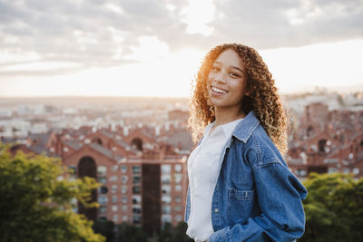 Portrait of smiling young woman standing outdoors