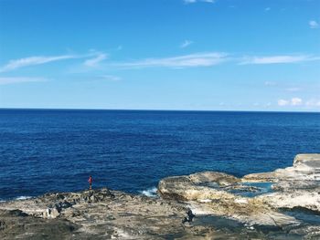 Scenic view of sea against blue sky