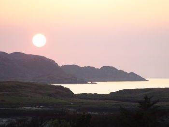 Scenic view of river at sunset