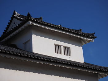 Low angle view of building against clear blue sky