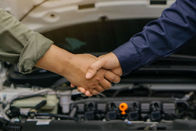 Midsection of man repairing car