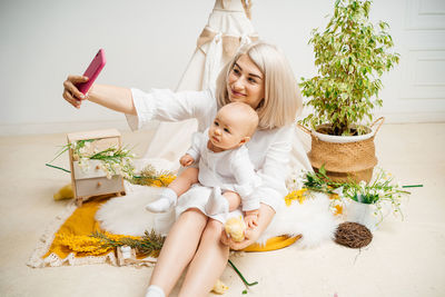 Portrait of girl playing with christmas tree