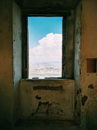 Abandoned building seen through window