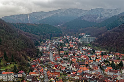 High angle view of townscape and mountains against sky