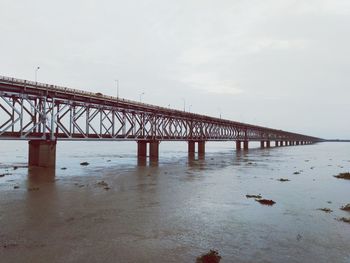 Bridge over sea against sky