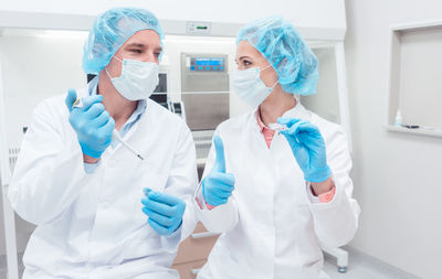 Close-up of man and woman having discussion in laboratory