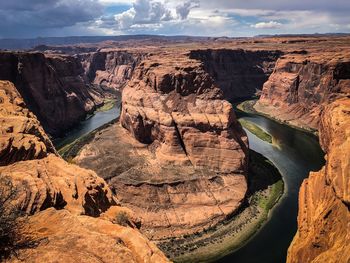 Aerial view of rock formations against cloudy sky