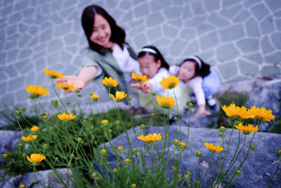 High angle view of woman with yellow flowers