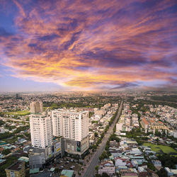 High angle view of buildings against cloudy sky during sunset