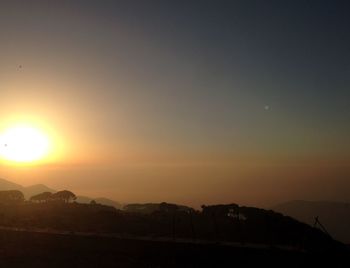 Scenic view of silhouette mountains against sky during sunset