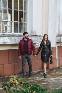 Portrait of young couple standing outdoors