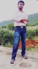 Portrait of young man standing against plants