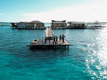 Aerial view of children playing at pier, in semporna, borneo sabah, malaysia.