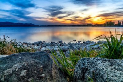 Scenic view of lake against sky during sunset