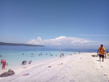 People on beach against sky