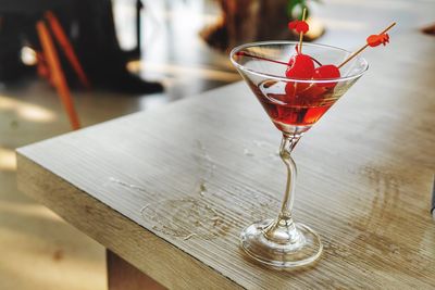 Close-up of red drink in martini on table