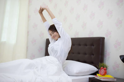 Woman relaxing on bed at home