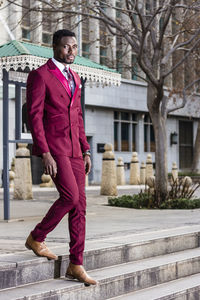 Full length of man standing against building in city