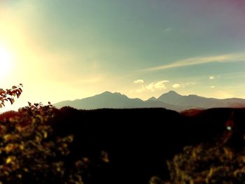 Scenic view of silhouette mountains against sky at sunset