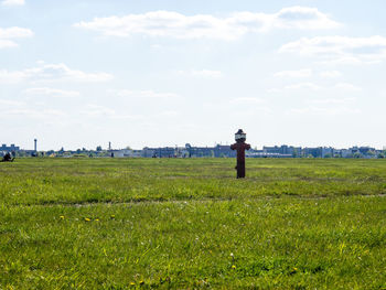 Metallic fire hydrant on field against sky