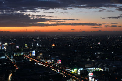 High angle view of illuminated buildings against sky at sunset