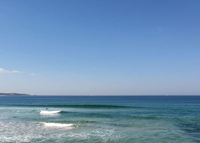 Scenic view of sea against clear blue sky